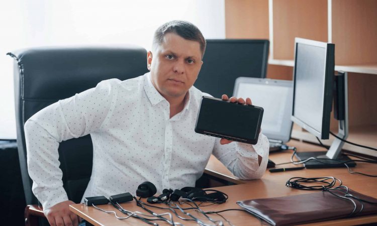 Some serious devices. Polygraph examiner works in the office with his lie detector's equipment.